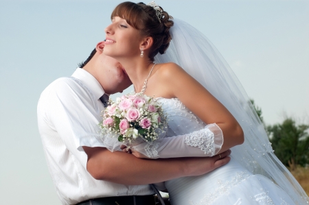 Happy bride and groom in wedding day outdoorsの写真素材