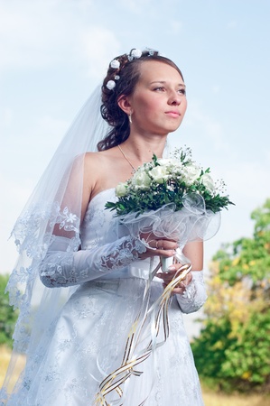 Beautiful happy bride looks downの写真素材