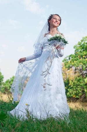 Beautiful happy bride looks downの写真素材