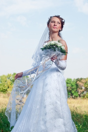 Beautiful happy bride looks downの写真素材
