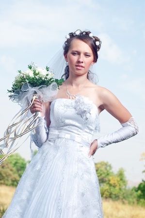 Beautiful happy bride looks downの写真素材