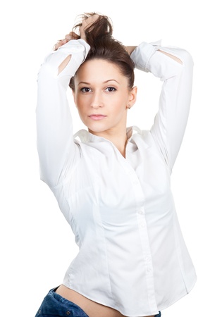Beautiful young woman with arms raised in a white shirt isolated on whiteの写真素材