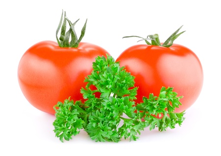 Two red juicy tomatoes and fresh parsley isolated on a white backgroundの写真素材