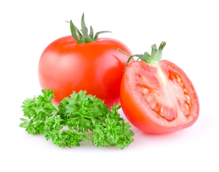 Fresh Juicy tomato cut in half and a sprig of parsley Isolated on white backgroundの写真素材