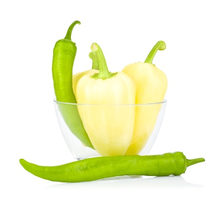 Yellow and green bell peppers bitter in Glass bowl isolated on a white backgroundの写真素材