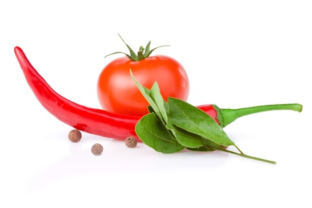 Fresh Red Hot Pepper, one Juicy tomato, pimento and bay leaves isolated on white backgroundの写真素材