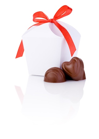 Two hearts chocolate and White gift box with a bow of red ribbon Isolated on white backgroundの写真素材