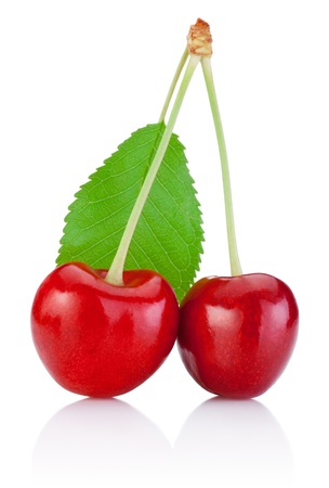 Two Cherry with stem isolated and a leaf on white backgroundの写真素材