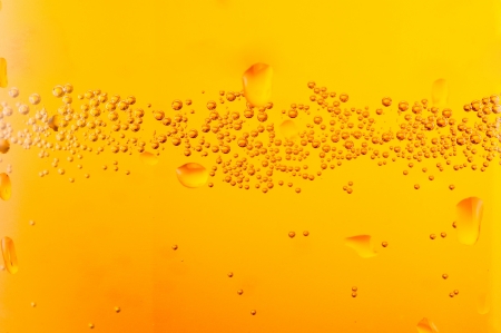 bubbles beer over yellowの写真素材