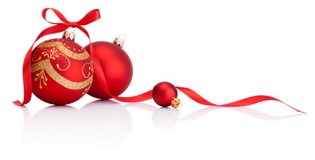 Red christmas decoration balls with ribbon bow isolated on white backgroundの写真素材