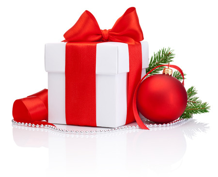 White gift box tied Red satin ribbon bow, Christmas ball and fir tree branch Isolated on white backgroundの写真素材