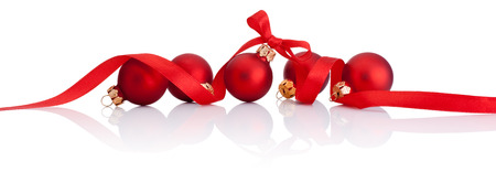 Red Christmas balls with ribbon bow Isolated on white backgroundの写真素材