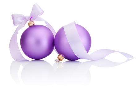 Two purple christmas balls with ribbon bow Isolated on white backgroundの写真素材