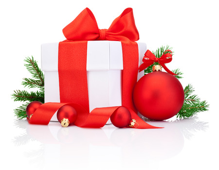 White gift box tied Red satin ribbon bow, Christmas ball and fir tree branch Isolated on white backgroundの写真素材