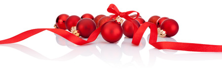 Red Christmas balls with ribbon bow Isolated on white backgroundの写真素材