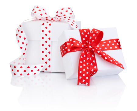 Two White boxs tied satin ribbon with heart symbol bow Isolated on white backgroundの写真素材