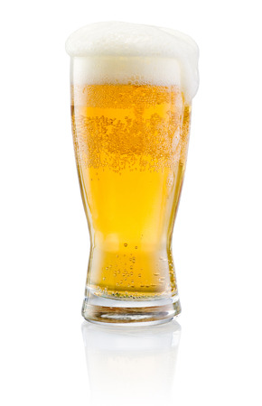 Glass of fresh beer with cap of foam isolated on white backgroundの写真素材