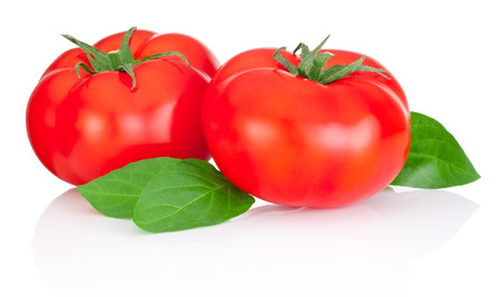 Two red tomatoes and leaves isolated on a white backgroundの写真素材