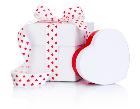 Two White boxs tied satin ribbon bow with heart symbol Isolated on white backgroundの写真素材