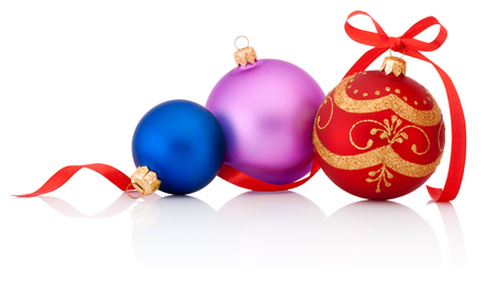Three colored Christmas baubles with ribbon bow isolated on white backgroundの写真素材