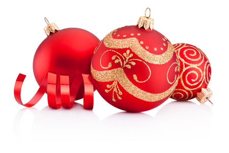 Red Christmas decoration baubles and curling paper isolated on white backgroundの写真素材