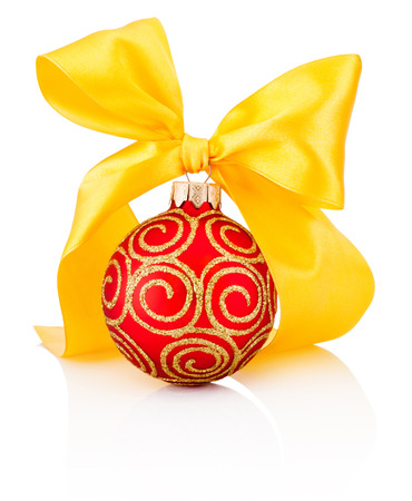 Red Christmas decoration bauble with yellow ribbon bow isolated on white backgroundの写真素材