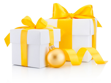 Two white gift boxes tied yellow ribbon bow and bauble Isolated on white backgroundの写真素材