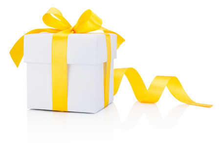 White gift box tied yellow ribbon bow Isolated on white backgroundの写真素材