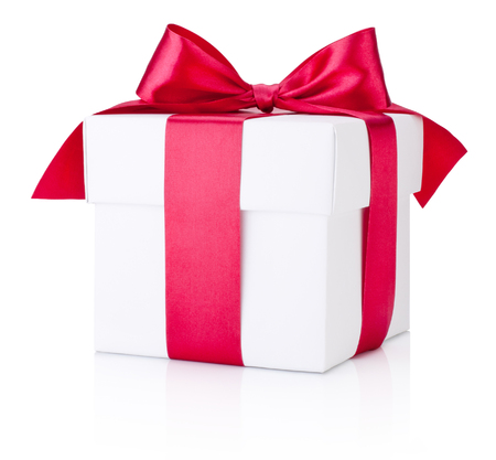 White gift box tied burgundy satin ribbon on a white backgroundの写真素材