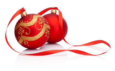 Two red Christmas decoration bauble with ribbon isolated on white backgroundの写真素材
