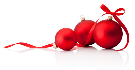 Three red Christmas decoration baubles with ribbon bow isolated on white backgroundの写真素材
