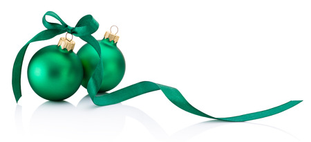Two green Christmas baubles with ribbon bow isolated on white backgroundの写真素材