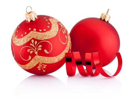 Two Red Christmas decoration baubles and curling paper isolated on white backgroundの写真素材