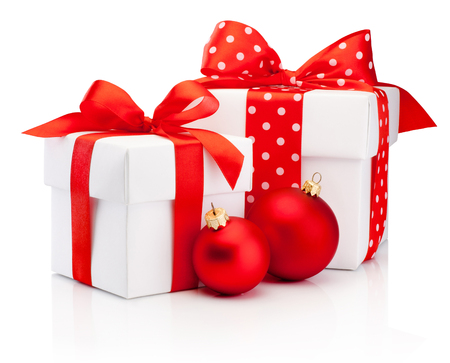 Two white gift box tied red ribbon bow and Christmas baubles Isolated on white backgroundの写真素材
