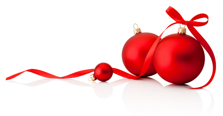 Three red Christmas decoration baubles with ribbon bow isolated on white backgroundの写真素材