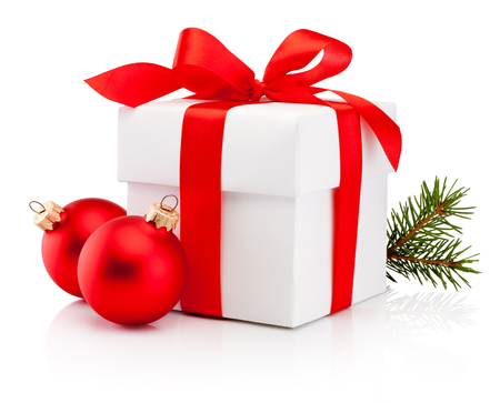 White gift box tied red ribbon bow and two Christmas bauble Isolated on white backgroundの写真素材