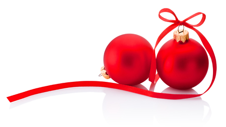 Two red Christmas bauble with ribbon bow isolated on white backgroundの写真素材
