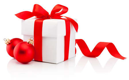 White gift box tied red ribbon bow and two Christmas bauble Isolated on white backgroundの写真素材