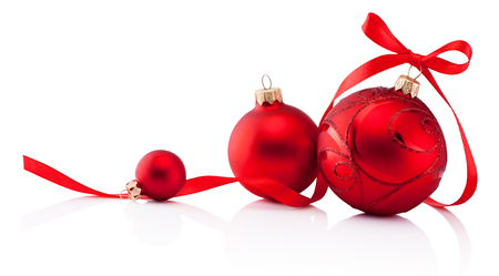 Three red Christmas decoration bauble with ribbon bow isolated on white backgroundの写真素材