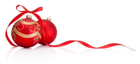 Two red Christmas decoration bauble with ribbon bow isolated on white backgroundの写真素材