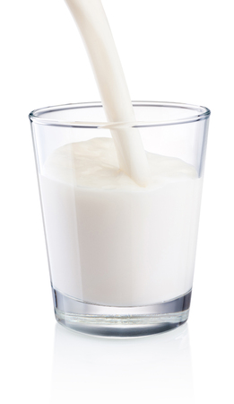 Pouring milk into glass isolated on white backgroundの写真素材