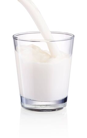 Pouring milk into glass isolated on a white backgroundの写真素材