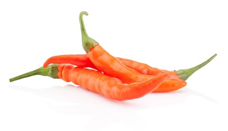 Three orange hot chili pepper isolated on a white backgroundの写真素材