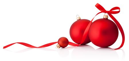 Three red Christmas baubles with ribbon bow isolated on a white backgroundの写真素材