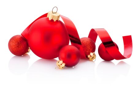 Christmas red baubles and curling paper Isolated on a white backgroundの写真素材