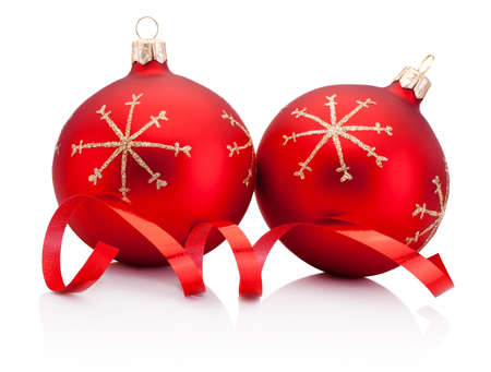 Two red Christmas decoration baubles and curling paper Isolated on a white backgroundの写真素材