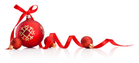 Red Christmas decoration baubles with ribbon bow isolated on a white backgroundの写真素材