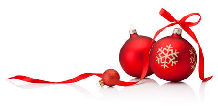 Three red Christmas baubles with ribbon bow isolated on a white backgroundの写真素材