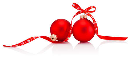 Two Christmas red bauble with ribbon bow isolated on a white backgroundの写真素材