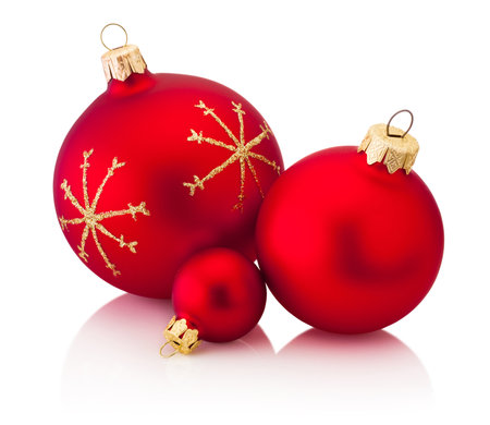 Three Christmas decoration red baubles isolated on a white backgroundの写真素材